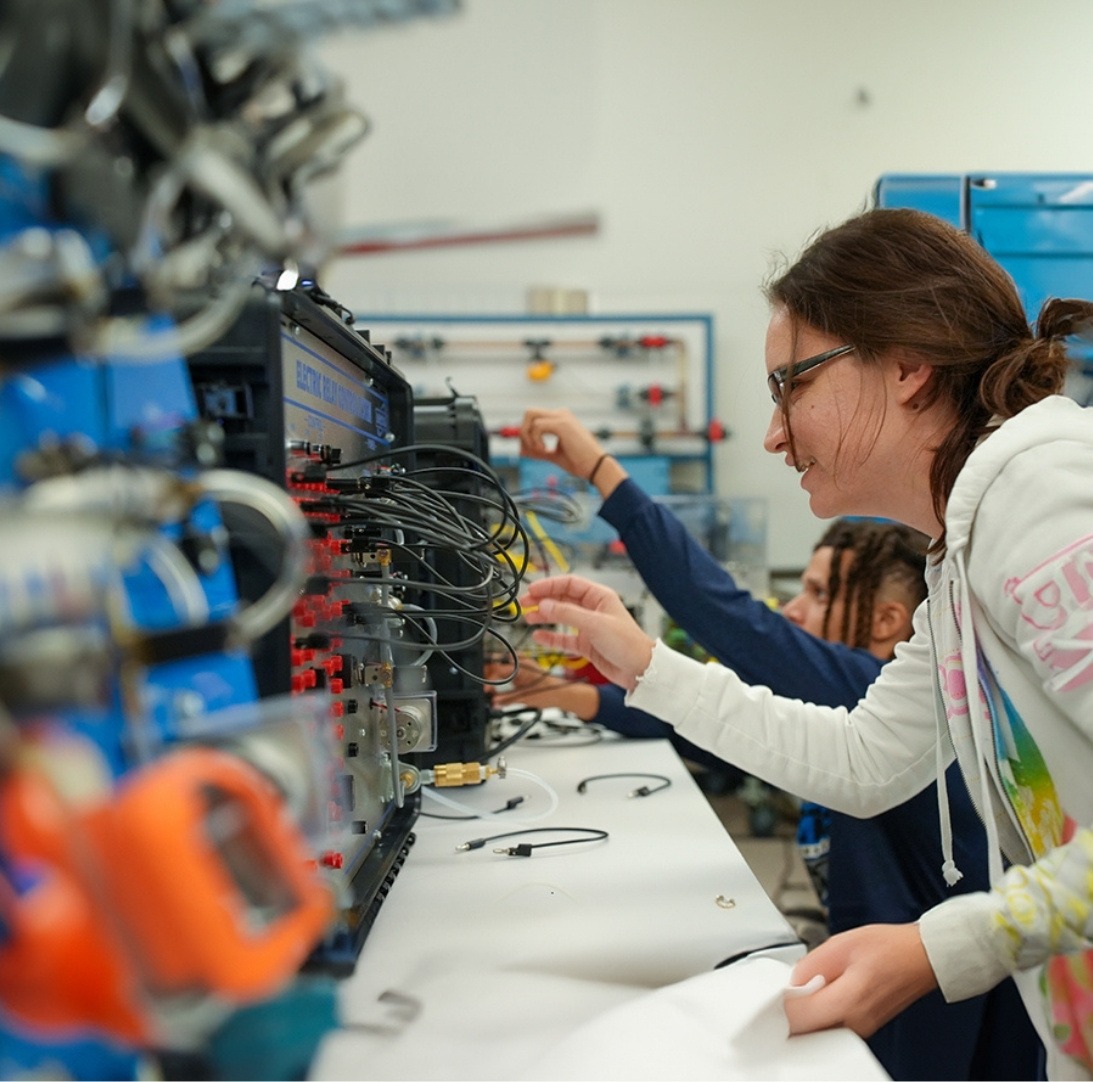 female student working with programmable logic controller