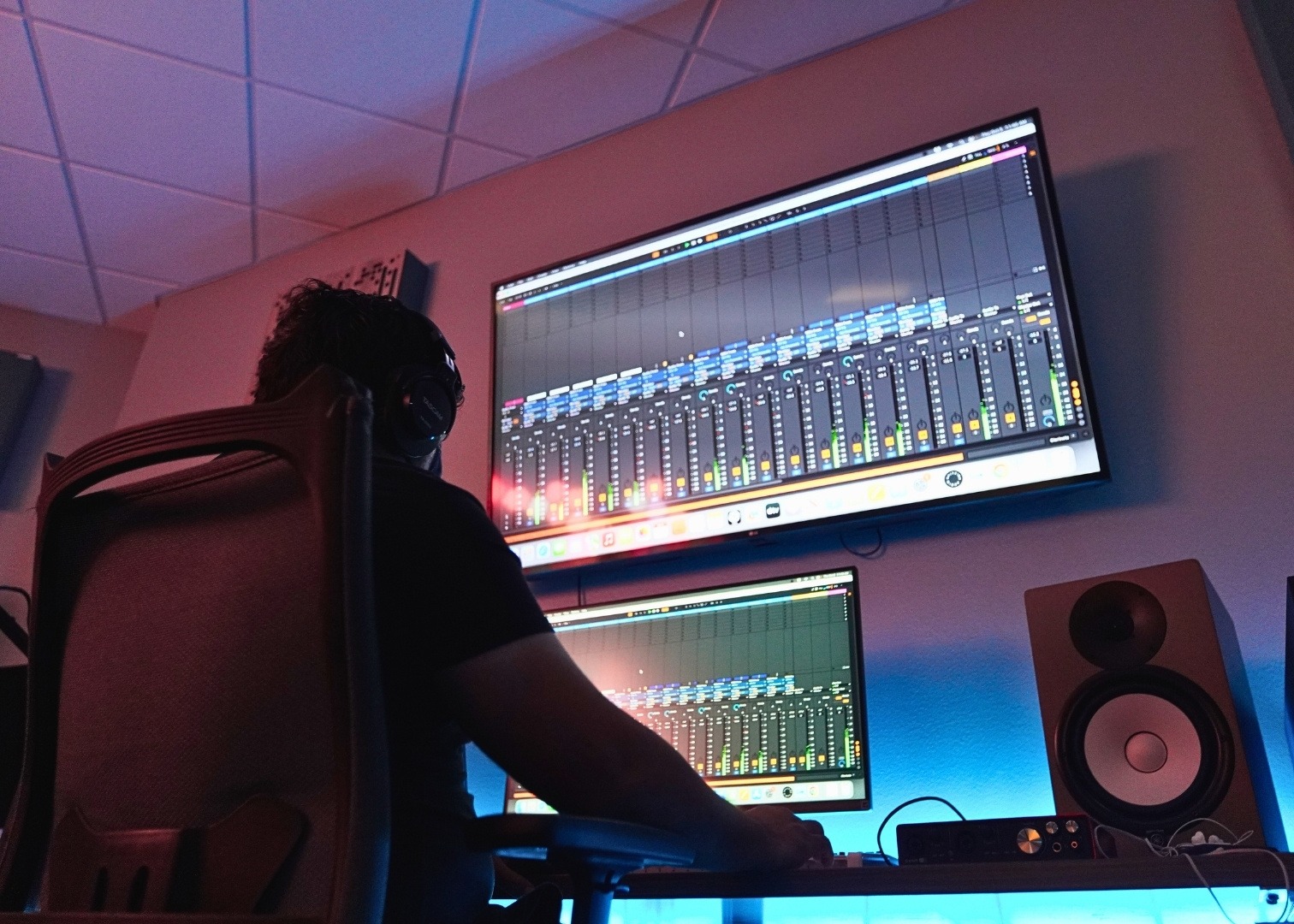 Music Production student working on multiple monitors in the production lab