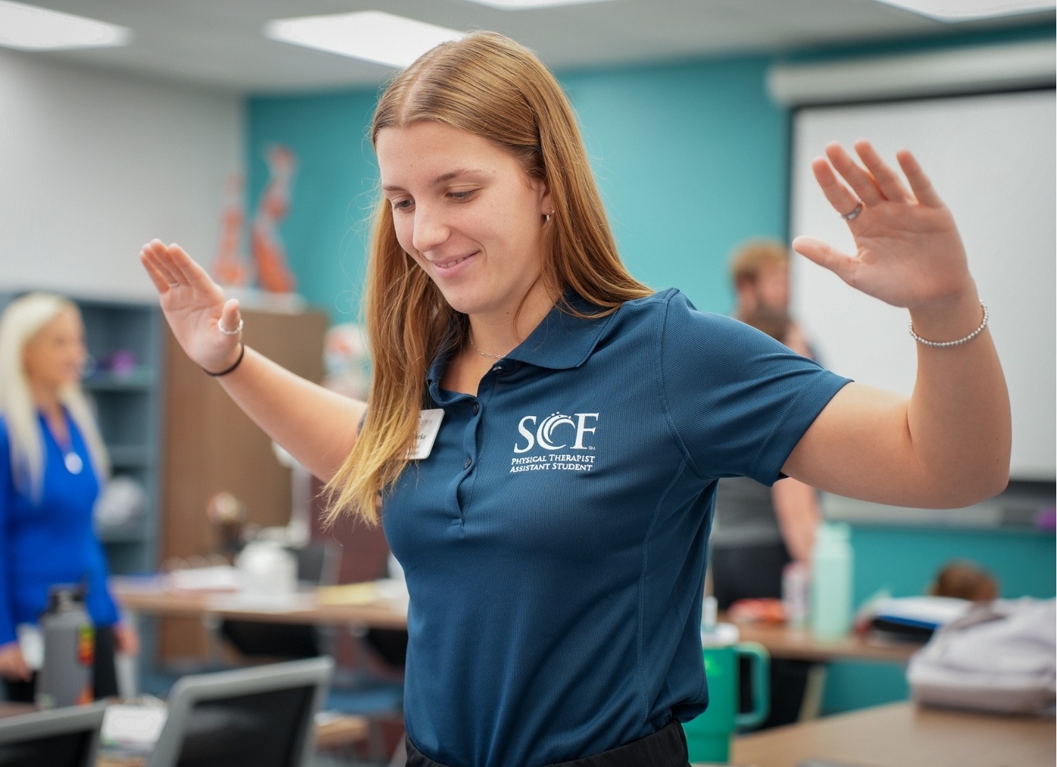 PTA student doing a stretching exercise in class